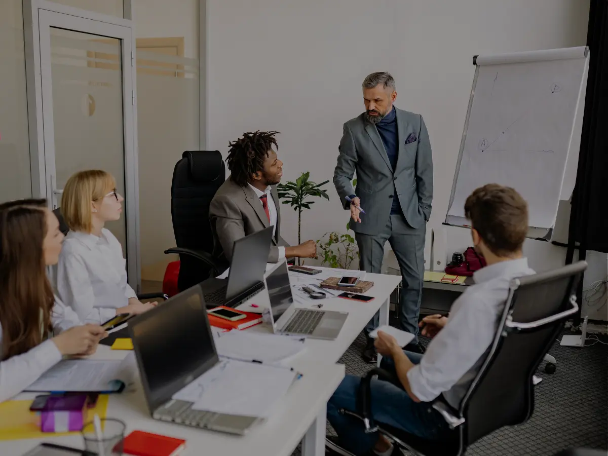Consultants discussing a business marketing plan around a table